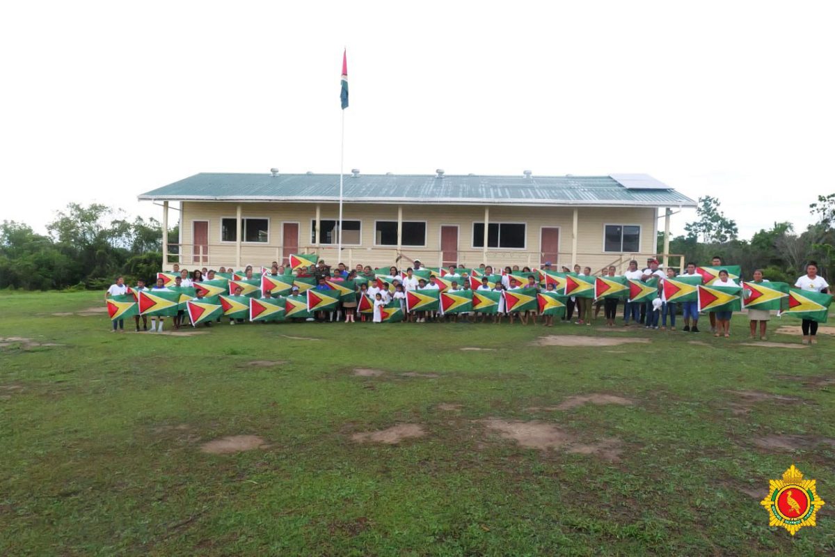 A sea of Guyana flags being held by children during a visit by the Chief of Defence Staff, Brigadier Omar Khan to Region Seven villages this week. (GDF photo)